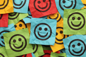 Crumpled adhesive notes with smiling faces
